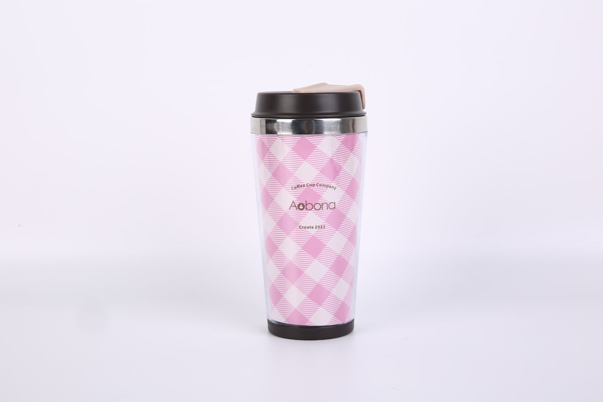 pink and black tumbler on white table